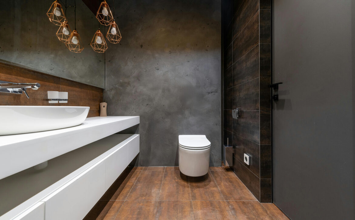Modern bathroom featuring a sleek smart toilet, minimalist sink design, and stylish pendant lighting, illustrating luxury smart home upgrades in New Jersey.